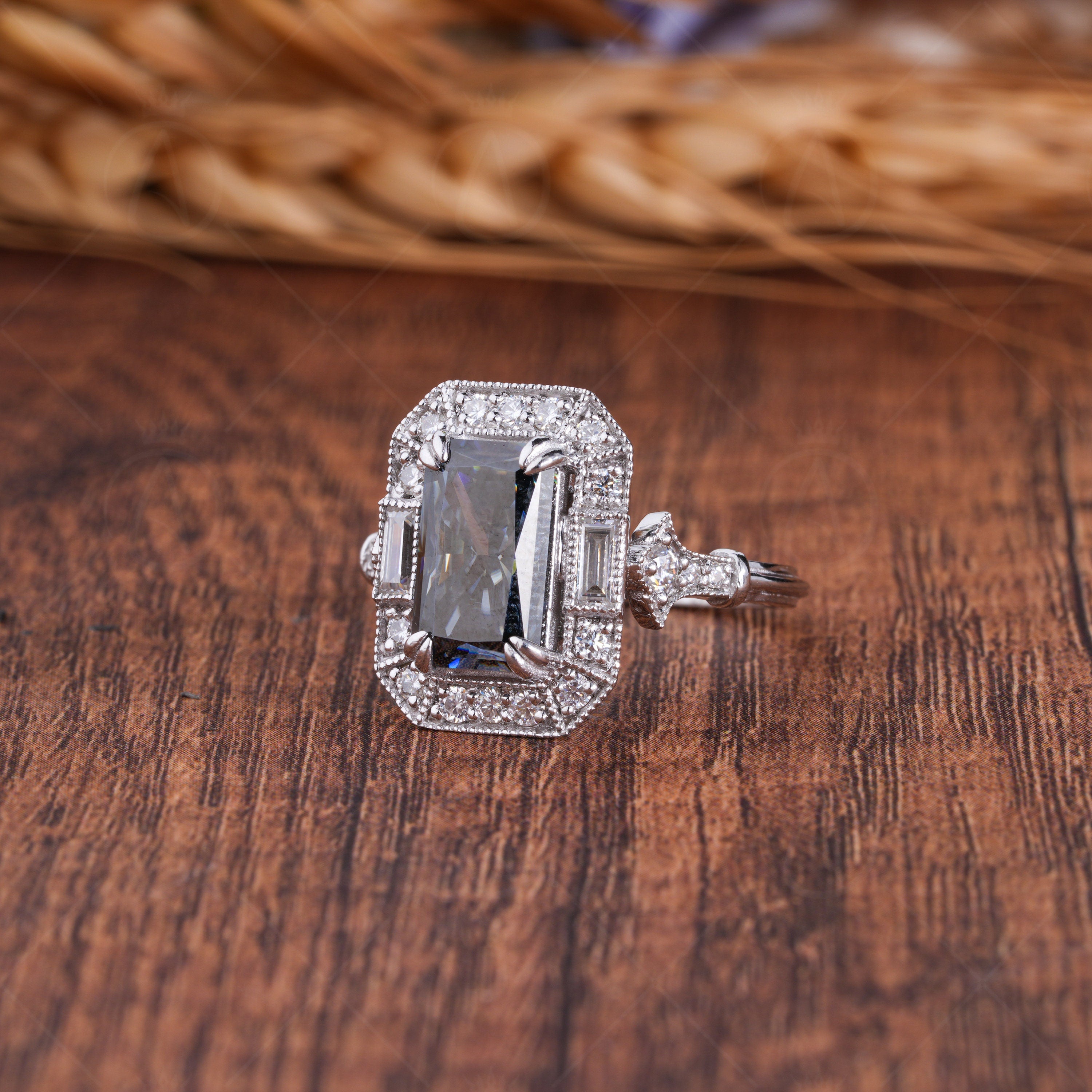 Elongated gray radiant cut Edwardian engagement ring with intricate vintage detailing. A timeless, elegant design perfect for romantic proposals.